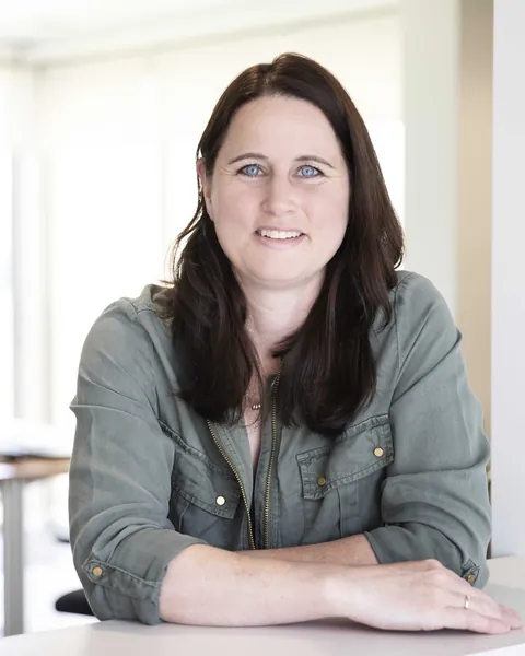 Barbara van Puijfelik aan tafel op kantoor
